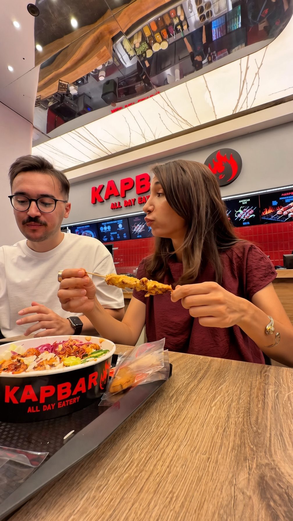 Inside Kap Bar — the sign and tables