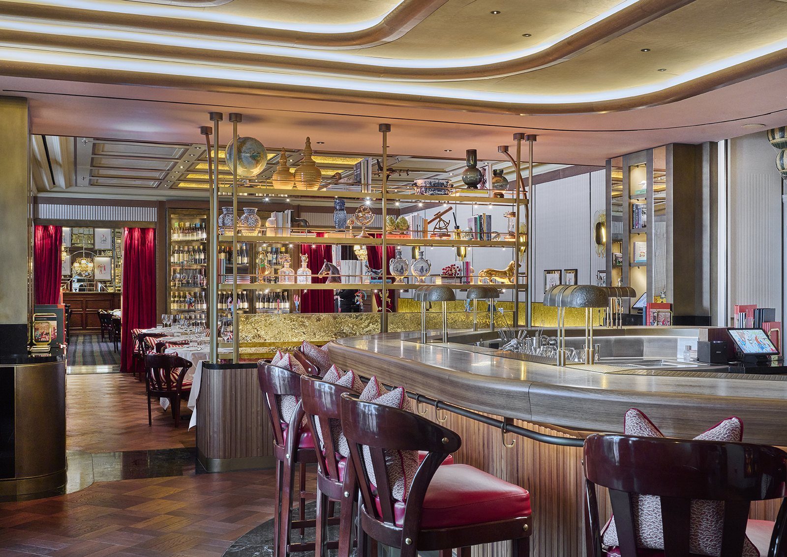 The dining room at Langosteria London, red-striped chairs and the wine wall