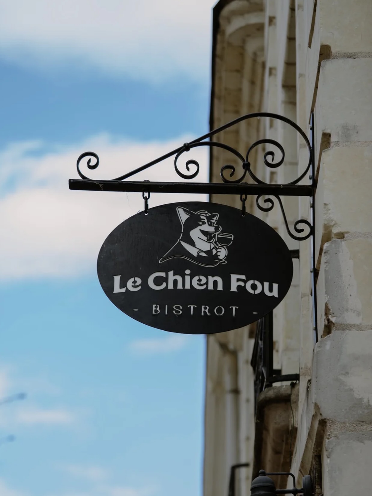 The hanging sign at Le Chien Fou